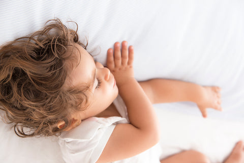  Young kid sleeping on a toddler mattress