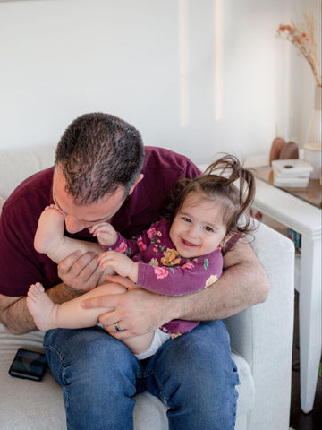 Dad playing with babies feet