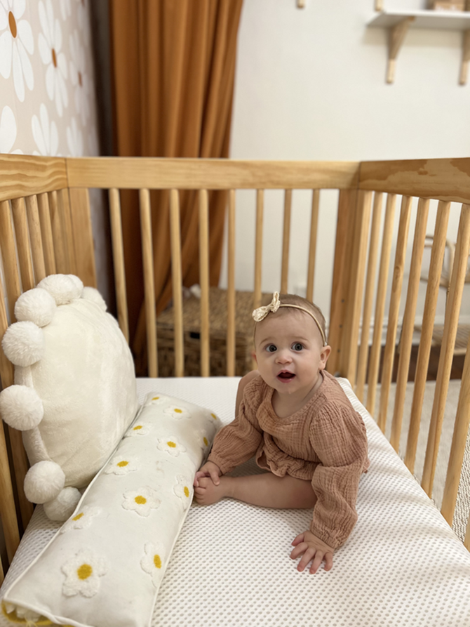 baby sitting up in crib