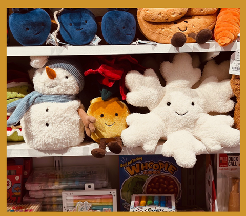 A photo of the Jellycat snowman, pointsetta and snowflake on our shelves in Colchester.