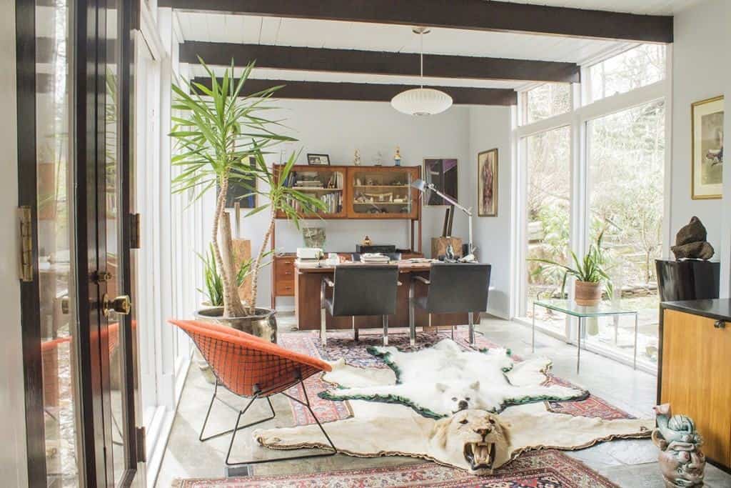 H. Wegner wall unit, George Nelson desk, Mies Bruno chairs in front of desk, Orange Bertoia diamond chair. Milo Baughman occassional table and a George Nelson side board.