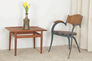 Mid Century modern Lyrical arm chair, unknown manufacturer and anonymous designer, next to a side table by Danish designer Greta Jalk.