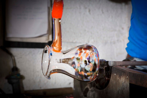 handmade multicolour glass pitcher lining up the handle