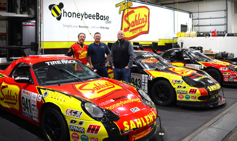 Will Nonnamaker from Team Sahlen and Jon Miller and Jason Yard from Malco Automotive at the Team Sahlen headquarters