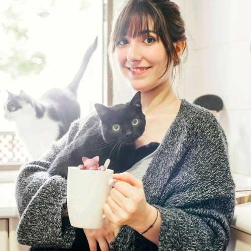 happy-woman-with-cup-coffee-holding-her-cat-webb