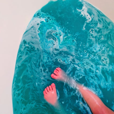 beautiful blue water that looks like the sky with some cute toes