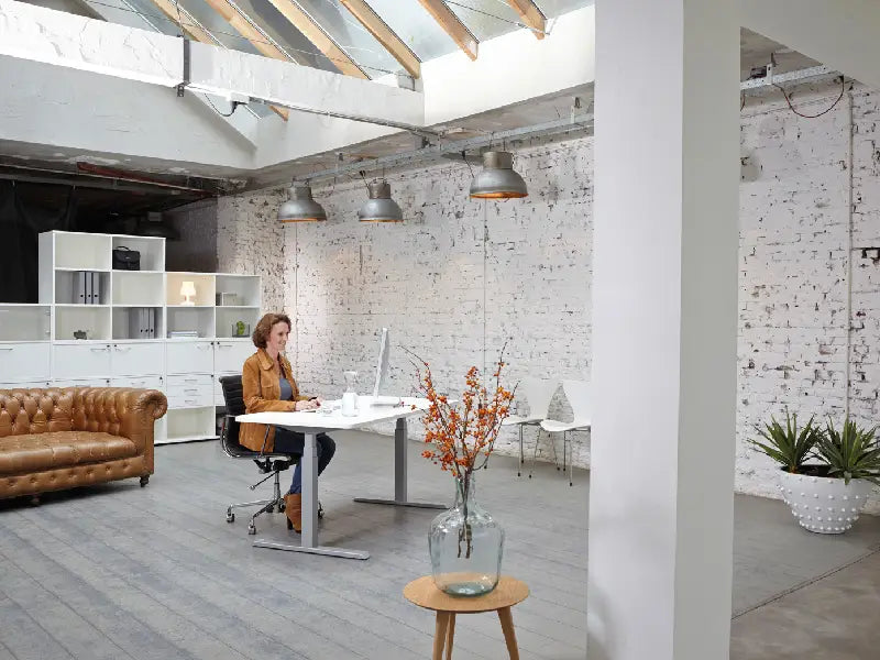 Happy Person Sitting At Leap Adjustable Desk