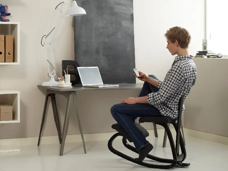 Man Using a Kneeling Chair in Office Variable