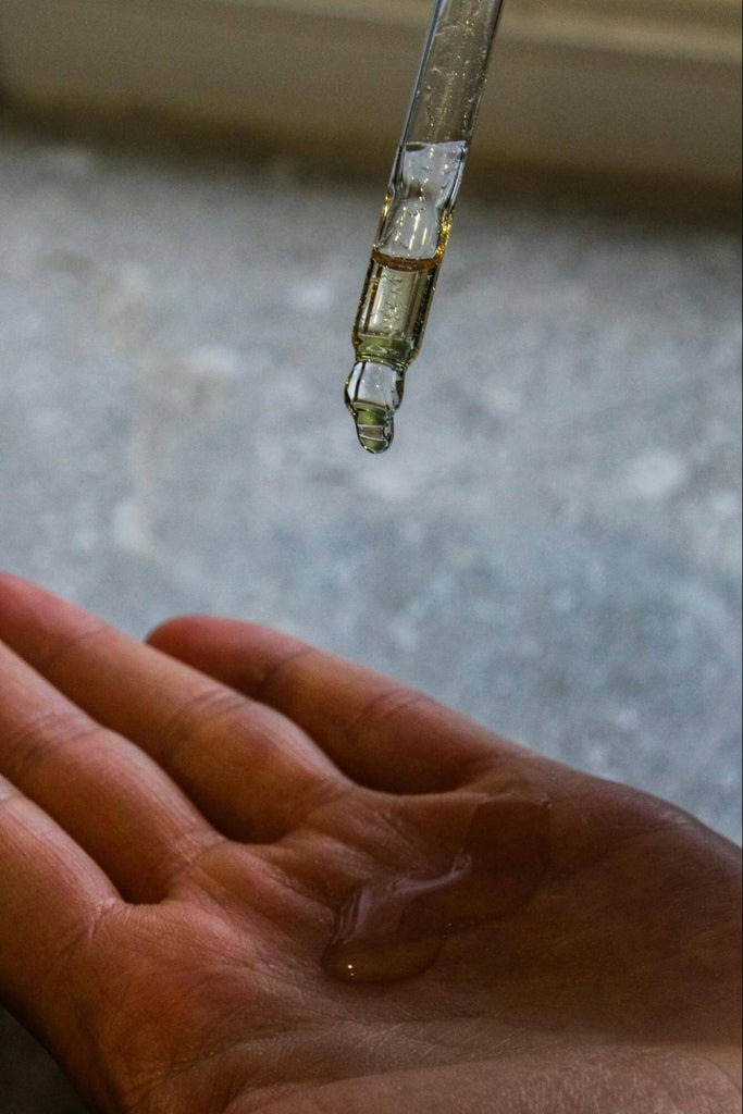 face serum dripping onto hand