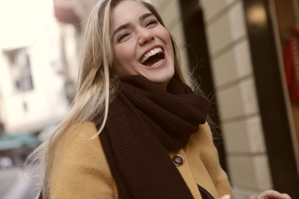 woman wearing scarf and heavy jacket smiling