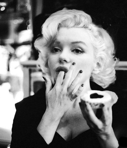 Marylin monroe is eating a piece of chocolate cake