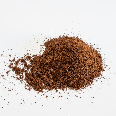 Coffee grinds against a white background.