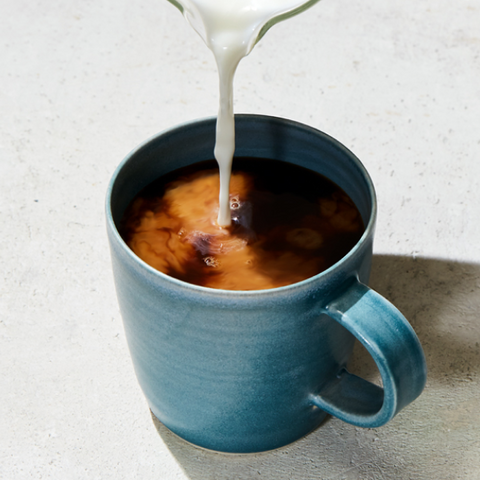 Milk being added to a cup of coffee.