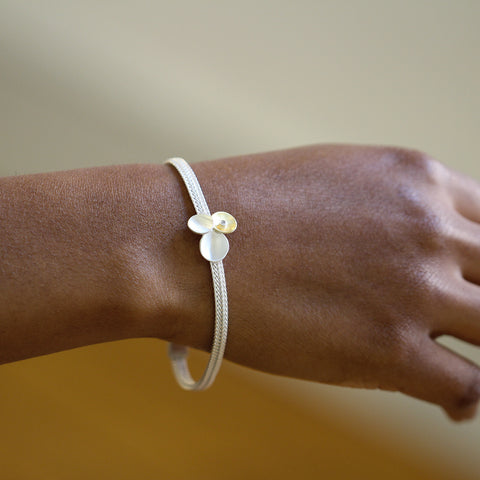 Model wears Trillium bracelet by Manu at designyard contemporary jewellery gallery dublin ireland
