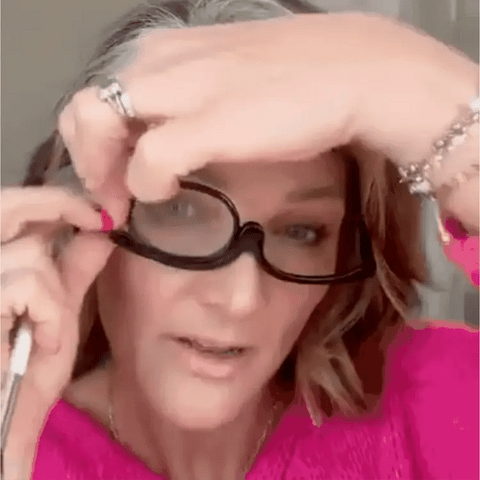 The BeautyLens Make-up Glasses are worn by a lady doing her make-up.