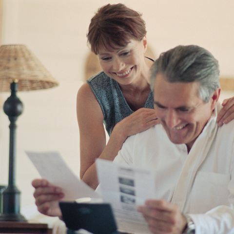 Couple-at-home-looking-at-paperwork