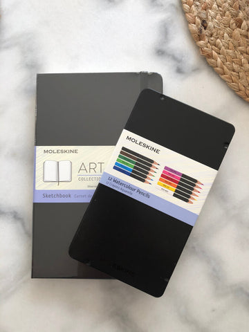 moleskine art sketchbook and colour pencils