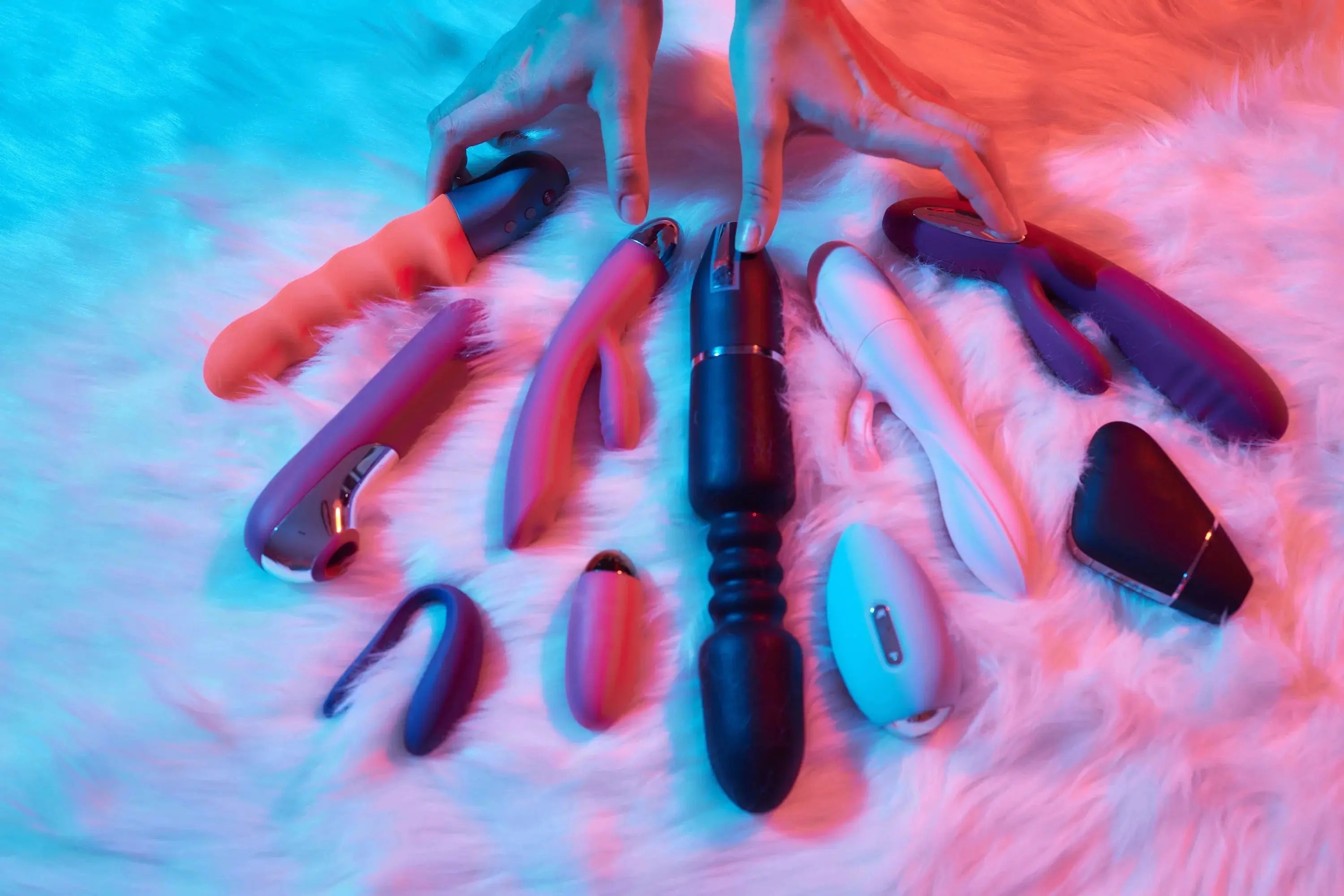 Vibrators on a fur blanket with a pink light - Flutters.ie