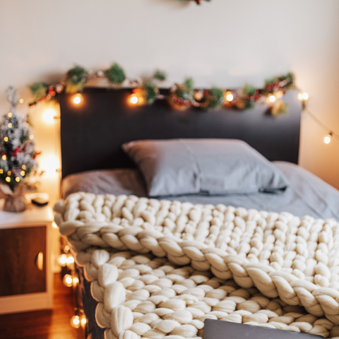 Bed decorated with seasonal accents like pine cones, winter wreaths, or snowy-themed decor.