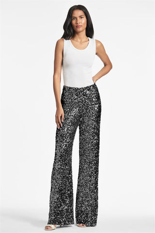 Black sequin pants with white top