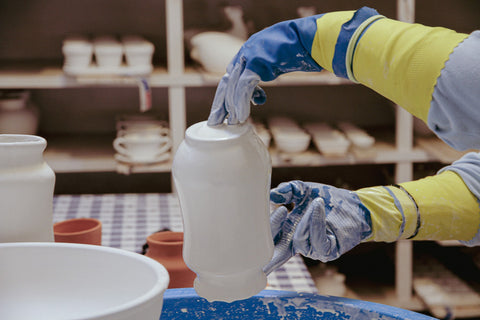 A pot being hand glazed