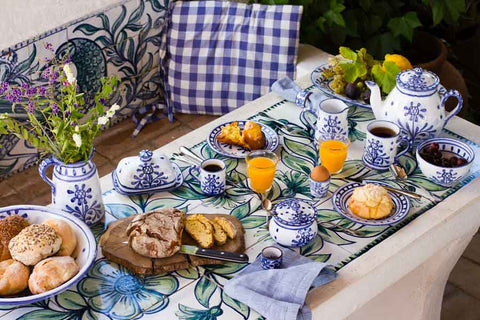 A breakfast table laid with Porches Pottery in the Artichoke design