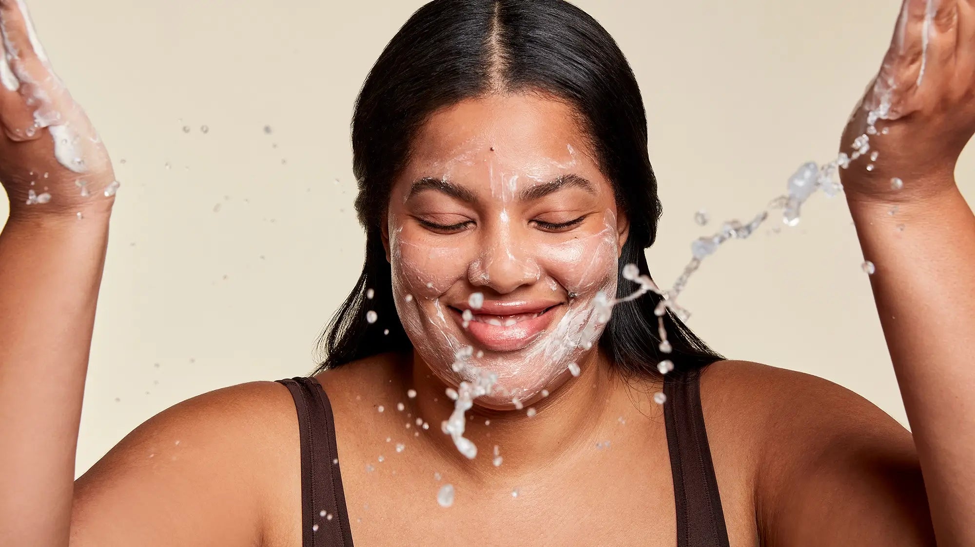 woman playfully washing her face