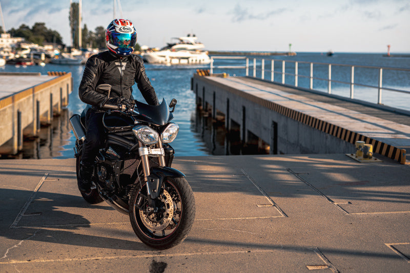 motorcyclist next to the sea en route dressed in Rebelhorn Brutale jacket