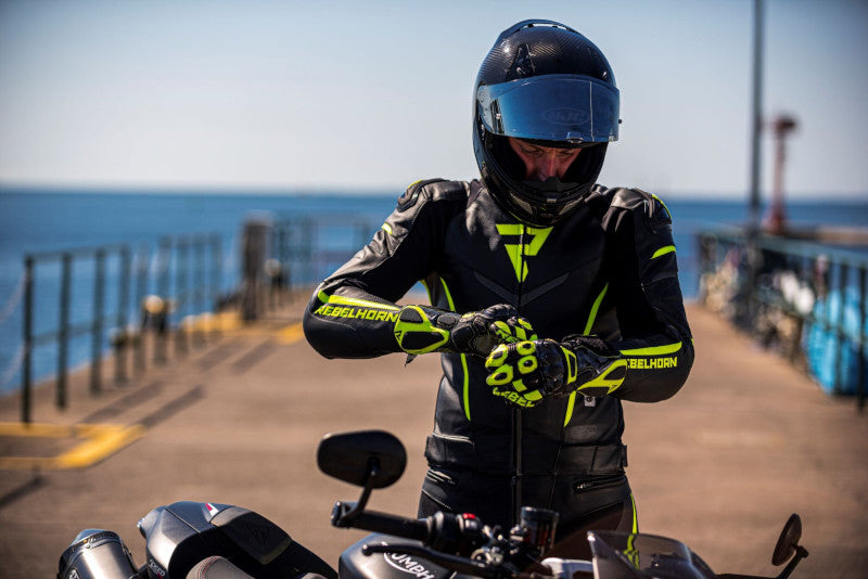 A man in a Rebelhorn Rebel fluogreen motorcycle suitIt