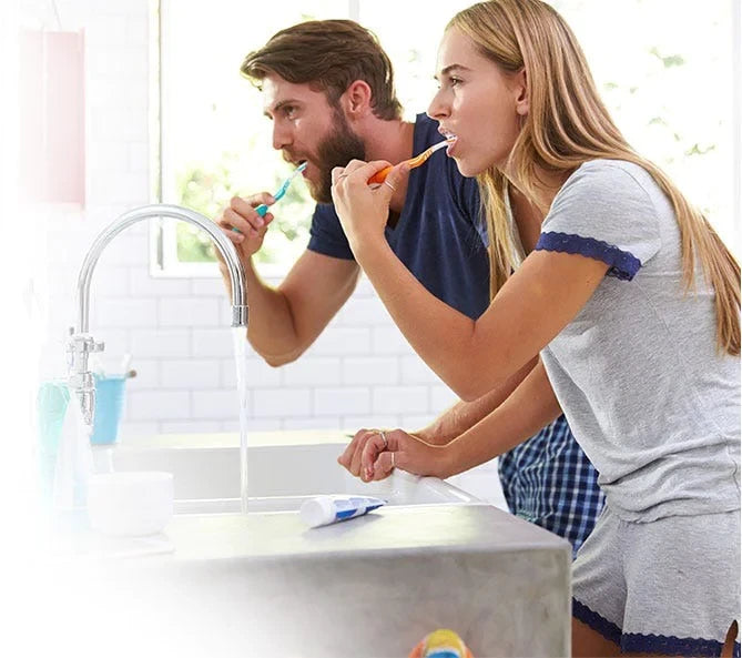 Husband and Wife brushing their teeth together in the morning