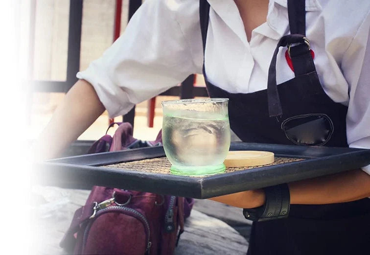 waitress serving water at a restaurant
