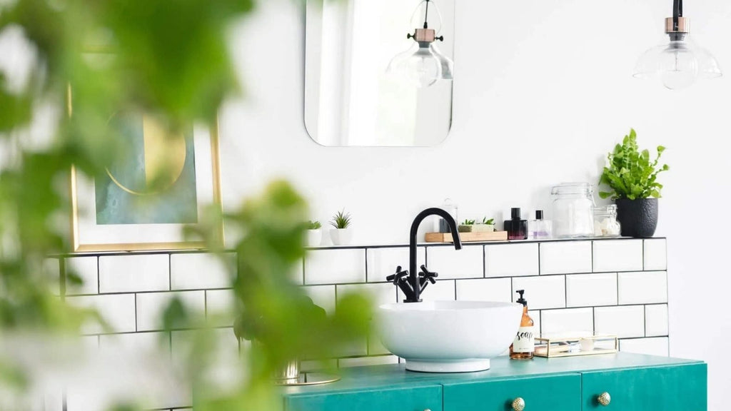 White bathroom with leafy green accents