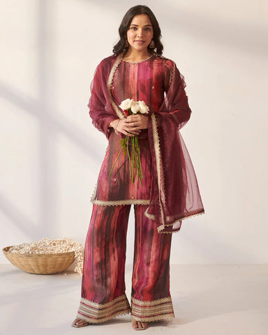 Elegant magenta suit set adorned with intricate Gota work for a traditional touch