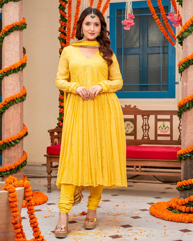 Elegant mustard suit set with intricate Mukaish work for a traditional and luxurious look