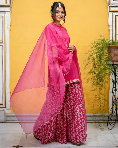 Elegant pink suit set adorned with intricate Tamba work