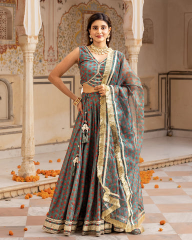 Fashionable green lehenga set in a vibrant hue, highlighted by elegant floral patterns and Gota work