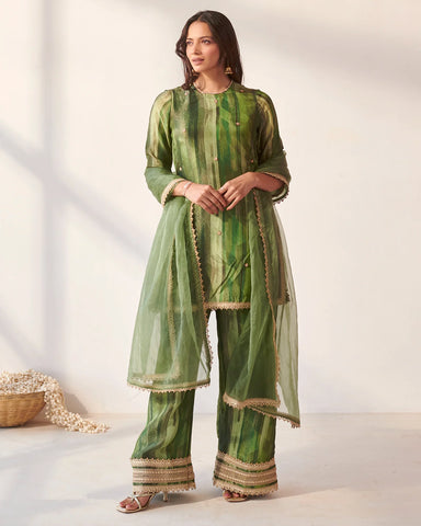 Modern emerald green suit set showcasing exquisite Gota work craftsmanship