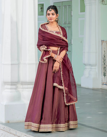 Modern tissue lehenga set in a deep wine color, offering a classic and timeless appeal