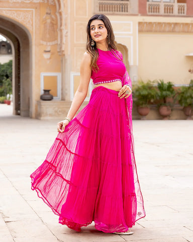 Stylish fuchsia lehenga set featuring tiers and playful tassels