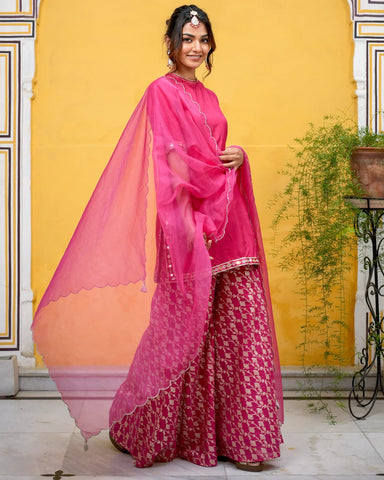 Stylish pink suit set adorned with intricate Tamba work patterns