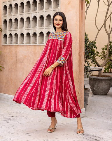 Vibrant red kurta set featuring tie-dye patterns and gathered details for a bohemian flair