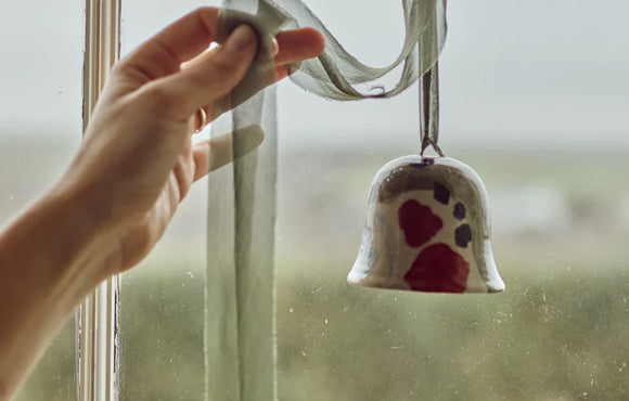 Hand displaying hand painted bell