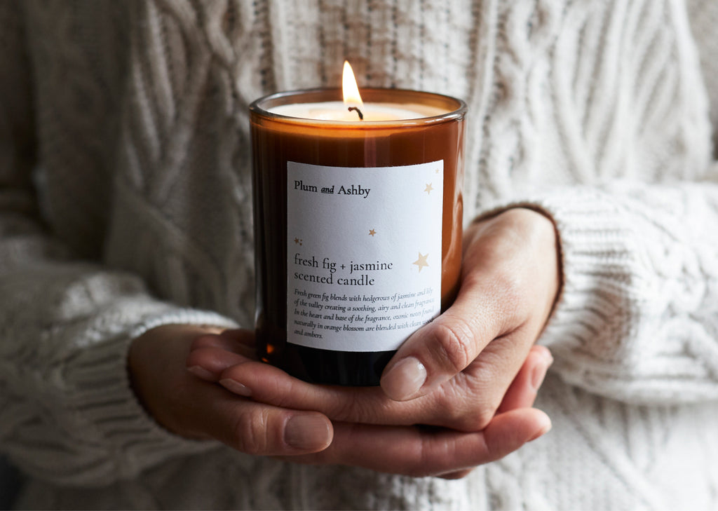 Tommy's and Plum and Ashby Charity Collaboration Candle held to chest in hands