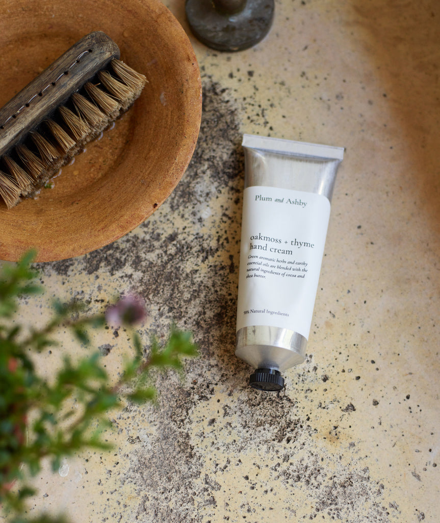 P&A hand cream in vintage scullery sink with plants and an old wooden nail brush in a terracotta dish