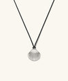 Amelia Shell Cord Necklace featuring an oversized silver shell pendant on a black cord, capturing a beach-inspired aesthetic for versatile, everyday wear.