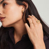 Woman wearing a black shirt and showcasing the Puffy Charlotte Gemstone Ring from the Charlotte Collection, featuring bold, eye-catching design elements.