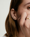 Celeste Lab Grown Diamond Halo Stud on woman's ear, featuring clustered diamonds in prong and bezel settings, inspired by constellations, ideal for ear stacking.