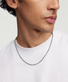 Close-up of a man's neck wearing a 2.4mm Wheat Chain Necklace in oxidized sterling silver.