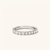 Bold Diamond Eternity Ring: Close-up of a silver ring adorned with round brilliant cut diamonds, each set in open prongs to enhance sparkle.