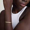 Close-up of a woman's wrist wearing a Round Box Chain ID Bracelet, showcasing its intricate metalwork and elegant design.